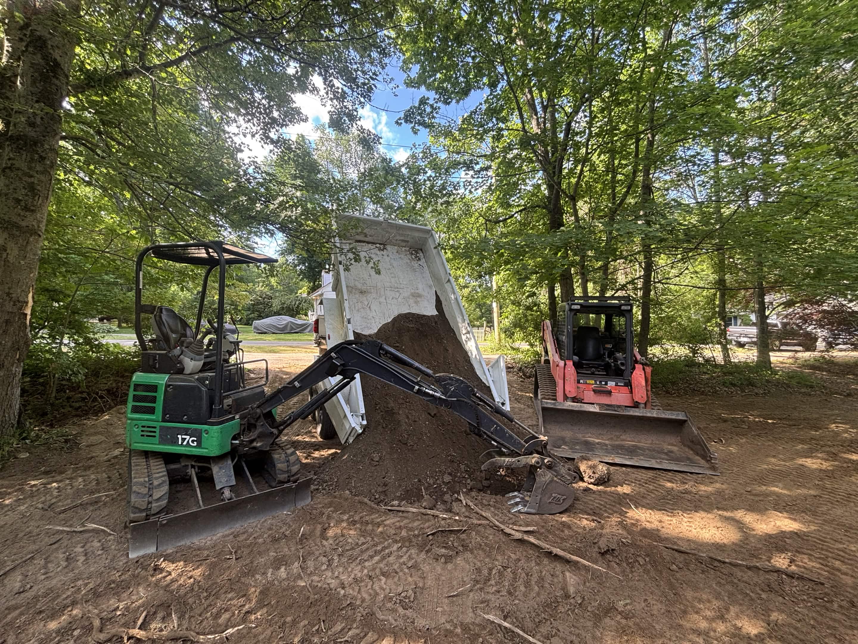 Lavallee Landscaping green mini, skid steer, and trailer